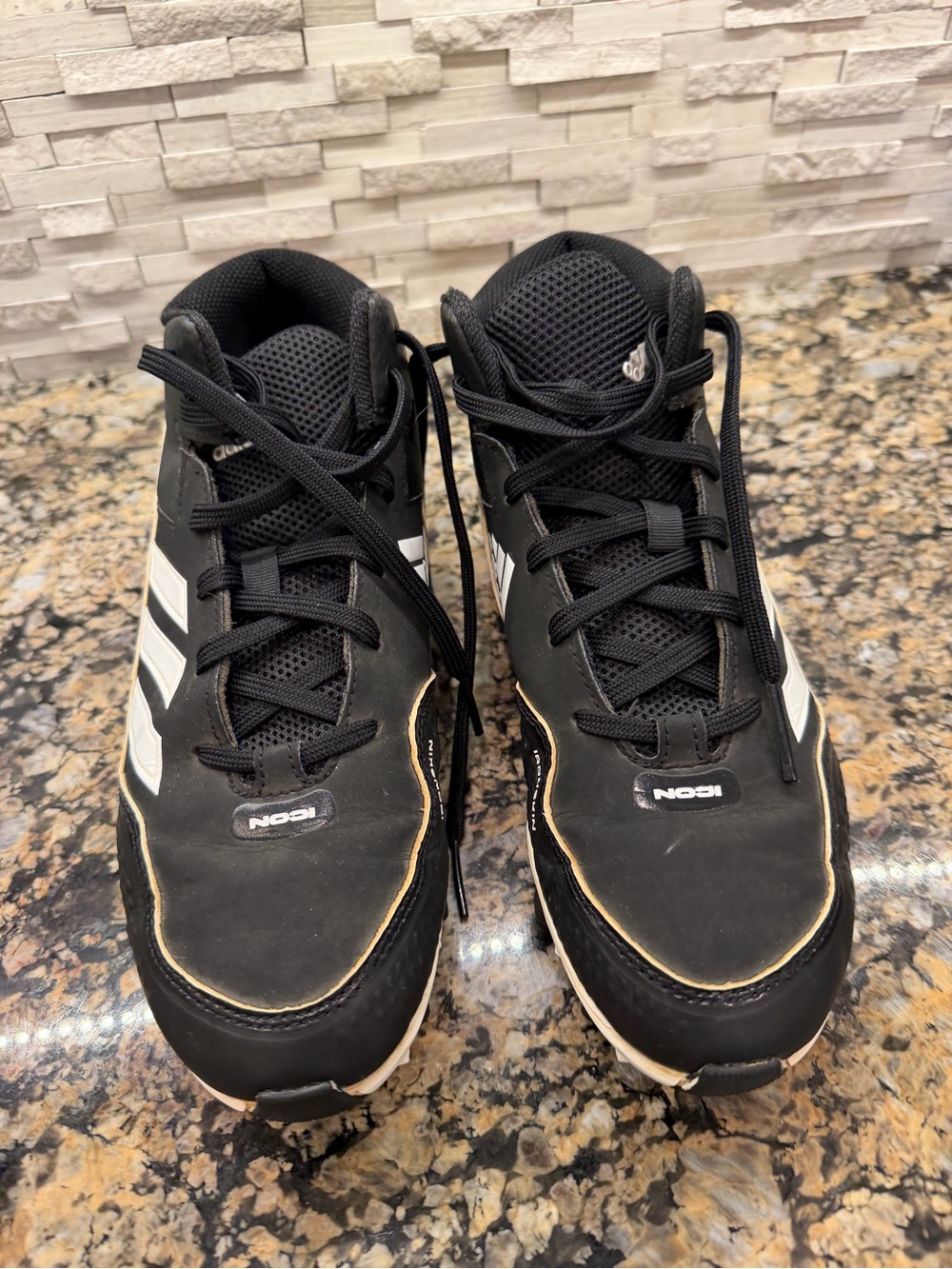 Adidas Icon Black baseball cleats with White Stripes